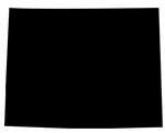 A solid black silhouette of a person in a wheelchair, depicted in profile, moving forward with one arm extended behind the wheel. This symbol is commonly used for accessibility near facilities like dumpster rentals near my location.