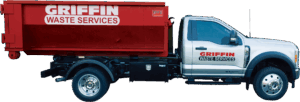A white pickup truck with the Griffin Waste Services logo on the door, showcasing their marketing at Griffin Waste, carries a large red dumpster labeled Griffin Waste Services along its side.